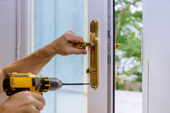 close up of a professional locksmith installing or repairing a new deadbolt lock